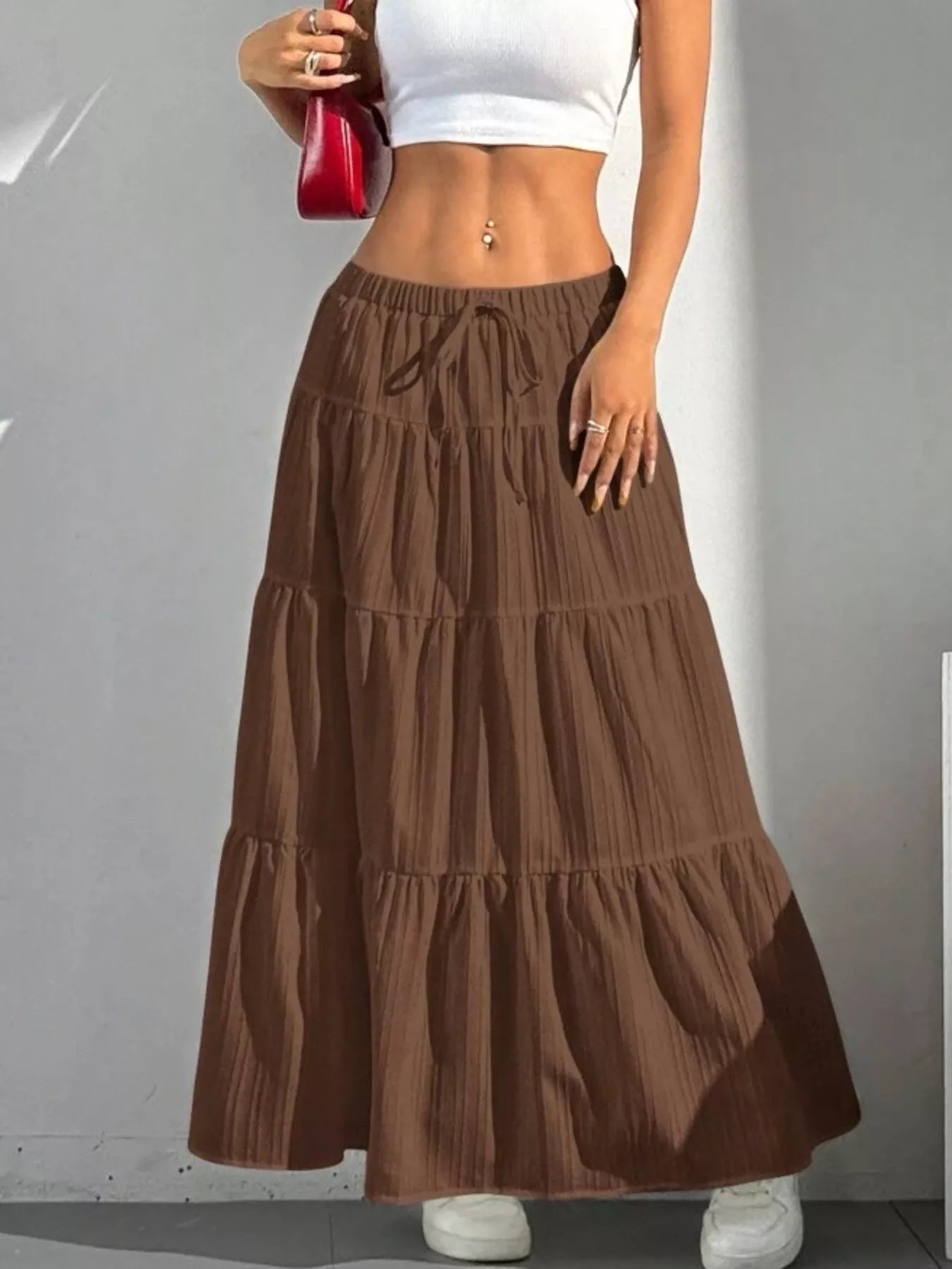 Brown tiered skirt worn by a person on a plain background