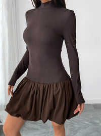 Brown ribbed long-sleeve top and skirt set against a white curtain background