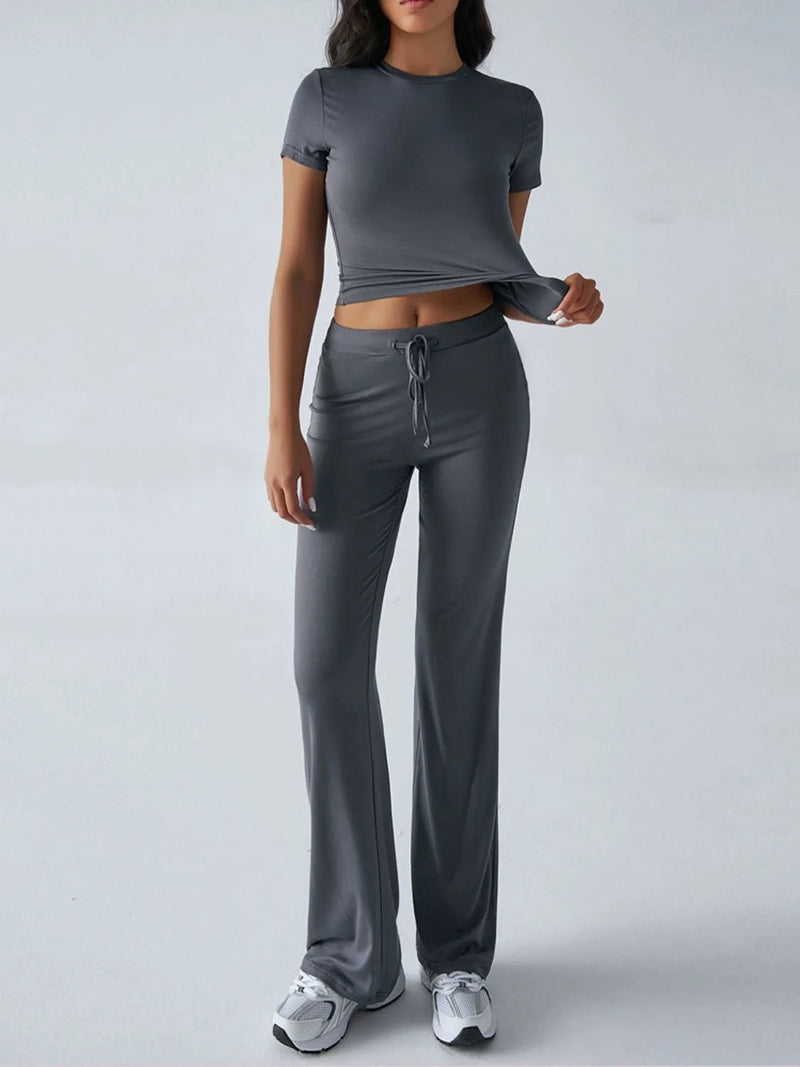 Person wearing a gray athletic outfit on a white background