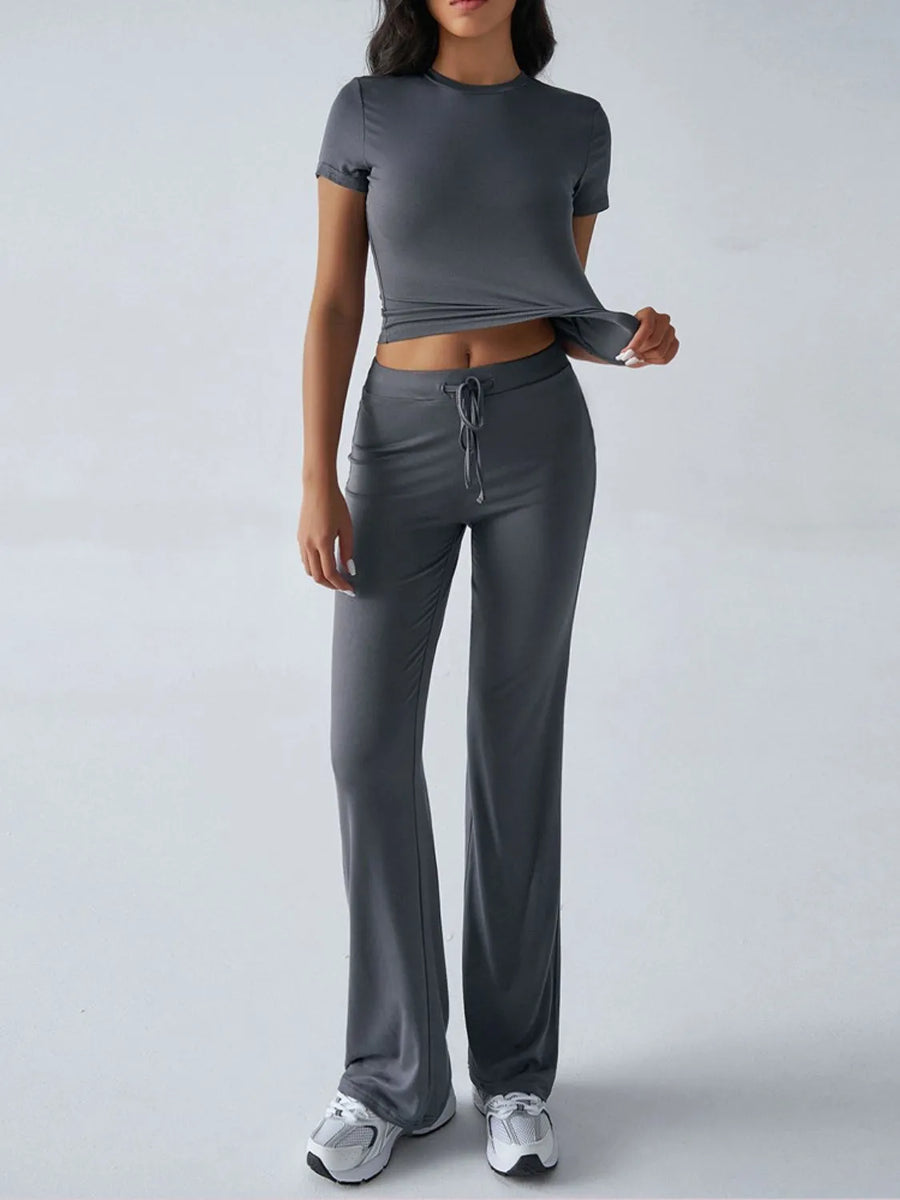 Person wearing a gray athletic outfit on a white background