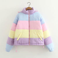 Pastel striped jacket on a hanger against a white background