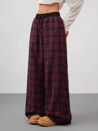 Plaid pants worn by a person on a plain background