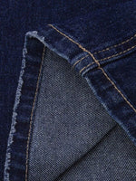 Close-up of blue denim fabric with stitching details