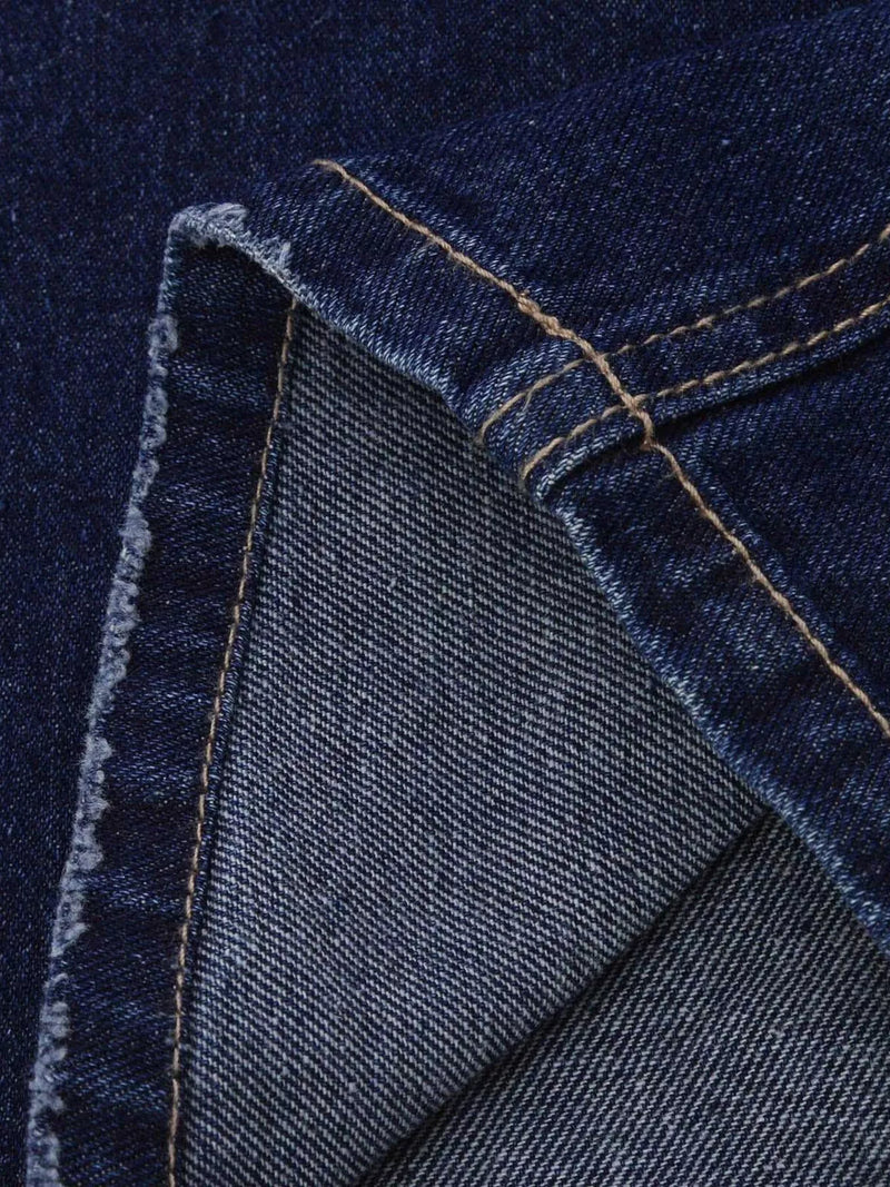 Close-up of blue denim fabric with stitching details