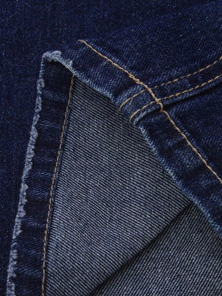 Close-up of blue denim fabric with stitching details