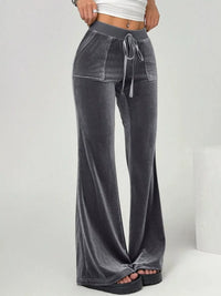 Gray velvet pants with a drawstring waist on a white background