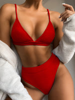 Person wearing a red bikini with a neutral background