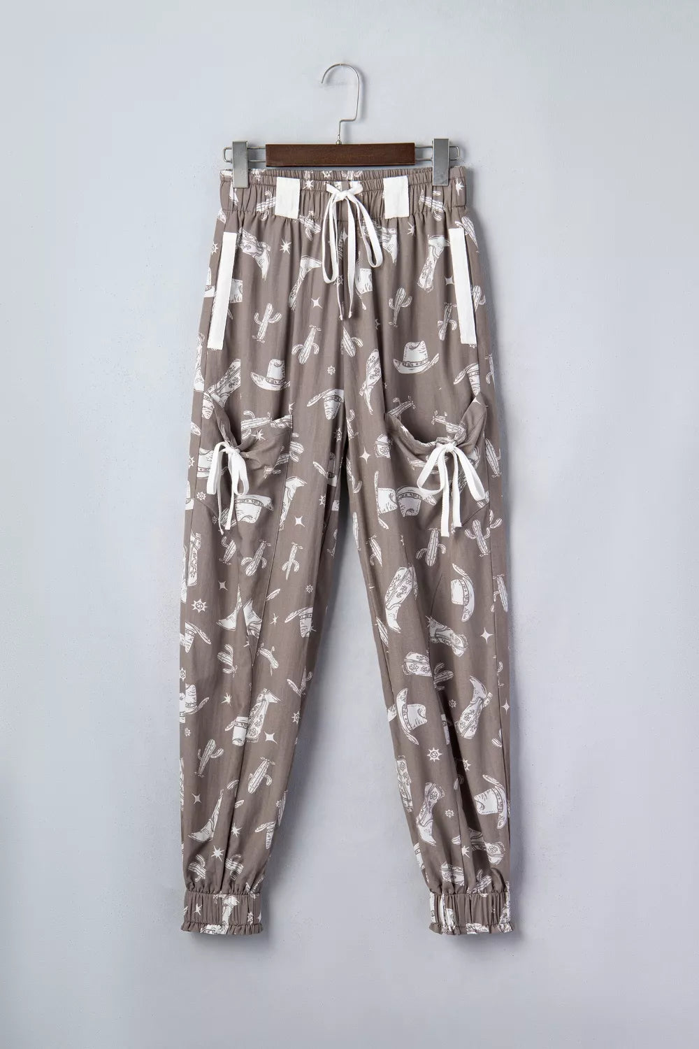 Patterned pants on a hanger against a plain background