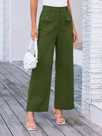 Person wearing green wide-leg pants with a white background