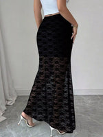 Black lace skirt worn by a person on a neutral background