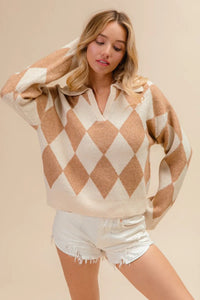 Woman wearing a diamond patterned sweater and white shorts on a beige background