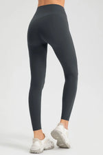 Dark gray leggings worn by a person on a white background