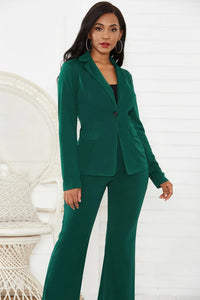 Woman wearing a green suit standing against a white background