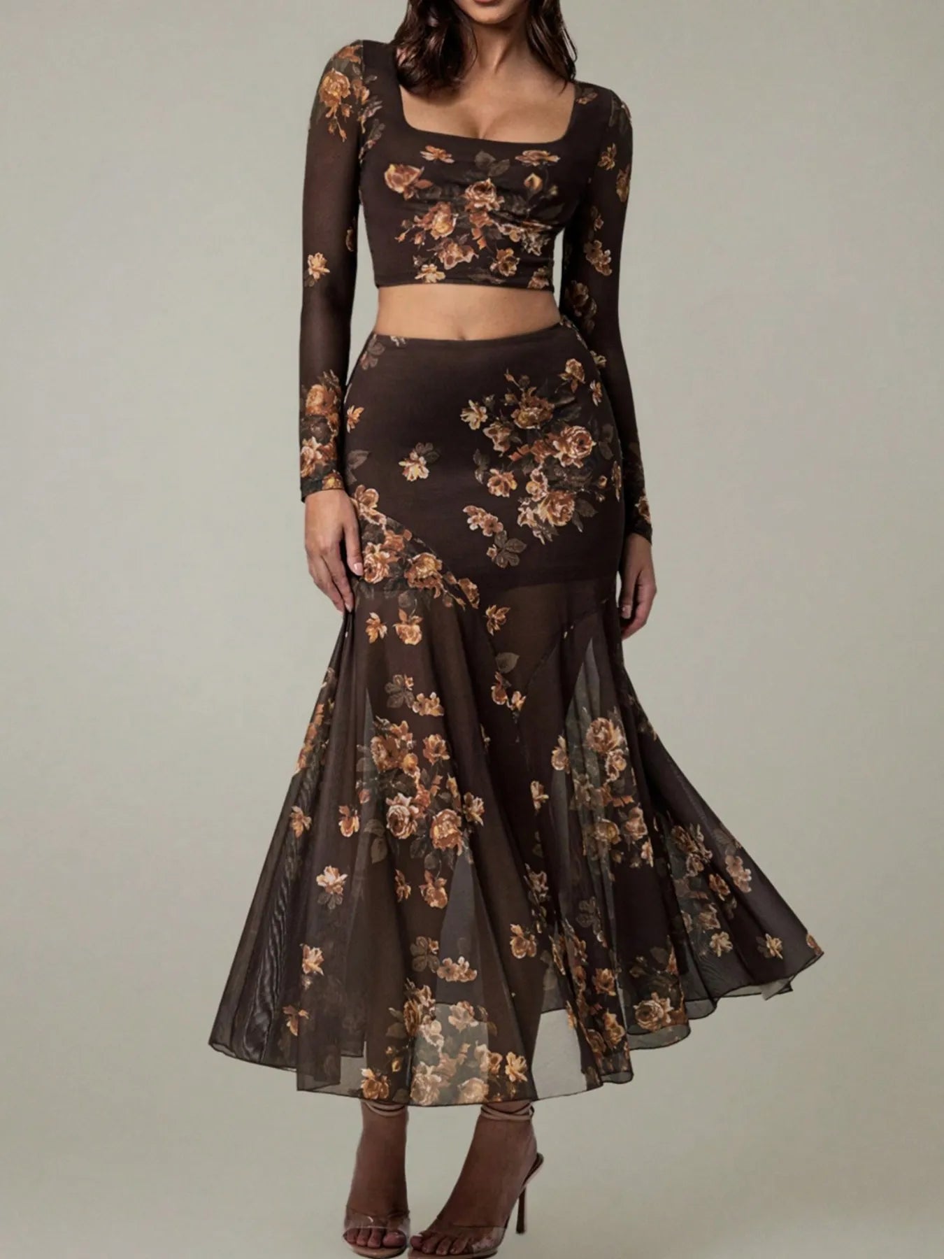 Dark floral dress with sheer sleeves on a neutral background