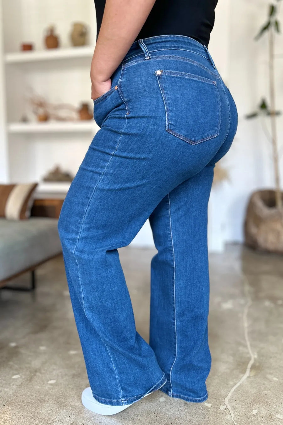 Person wearing blue jeans in an indoor setting