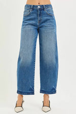 Blue jeans worn by a person on a light gray background