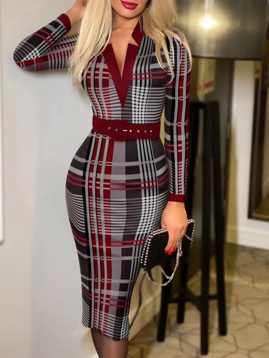 Woman wearing a plaid dress with a red belt in an indoor setting.
