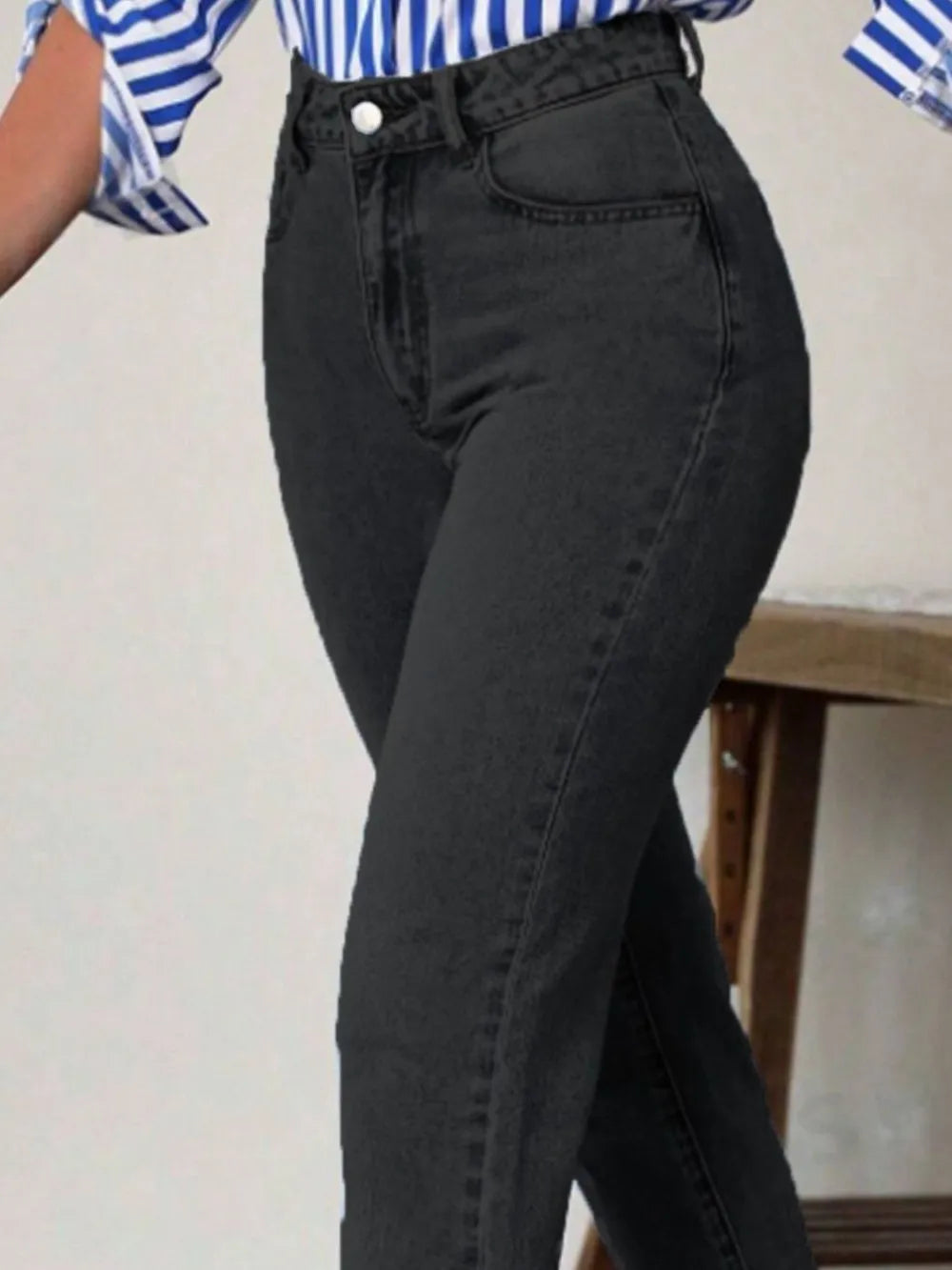 Person wearing black jeans with a blurred background
