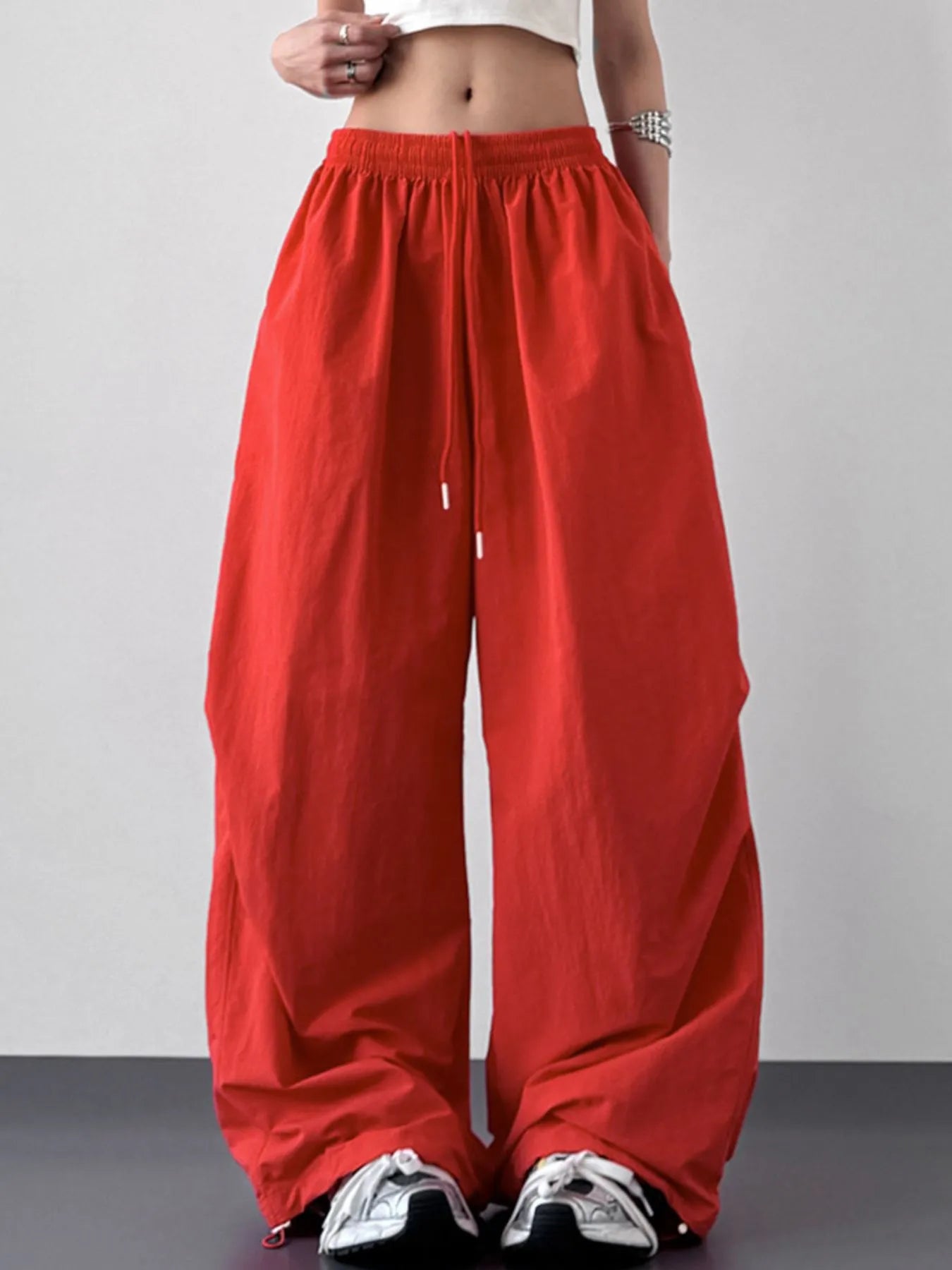 Red wide-leg pants worn by a person on a plain background