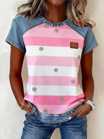 Person wearing a pink and white striped shirt with denim sleeves and pants.