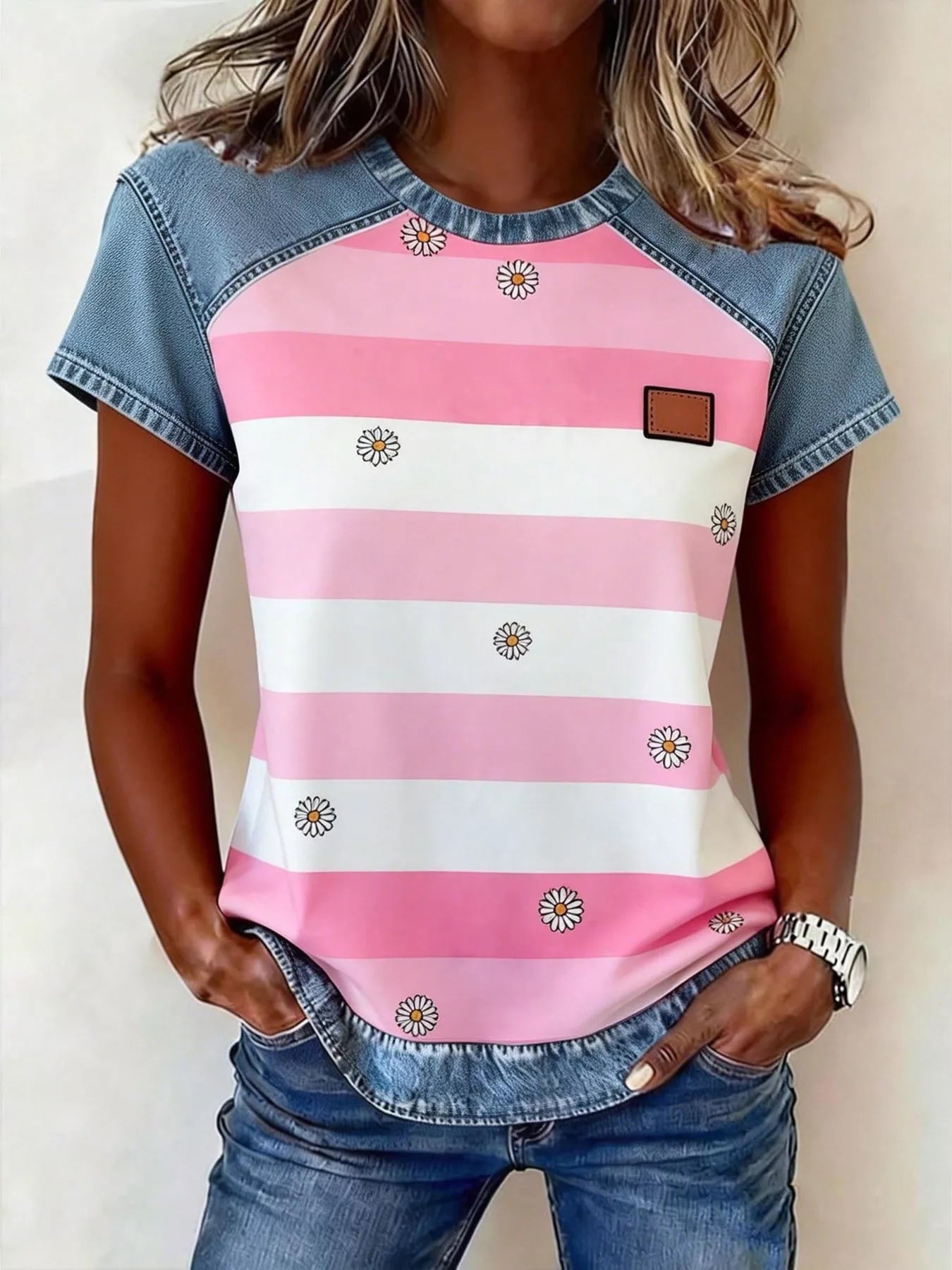 Person wearing a pink and white striped shirt with denim sleeves and pants.