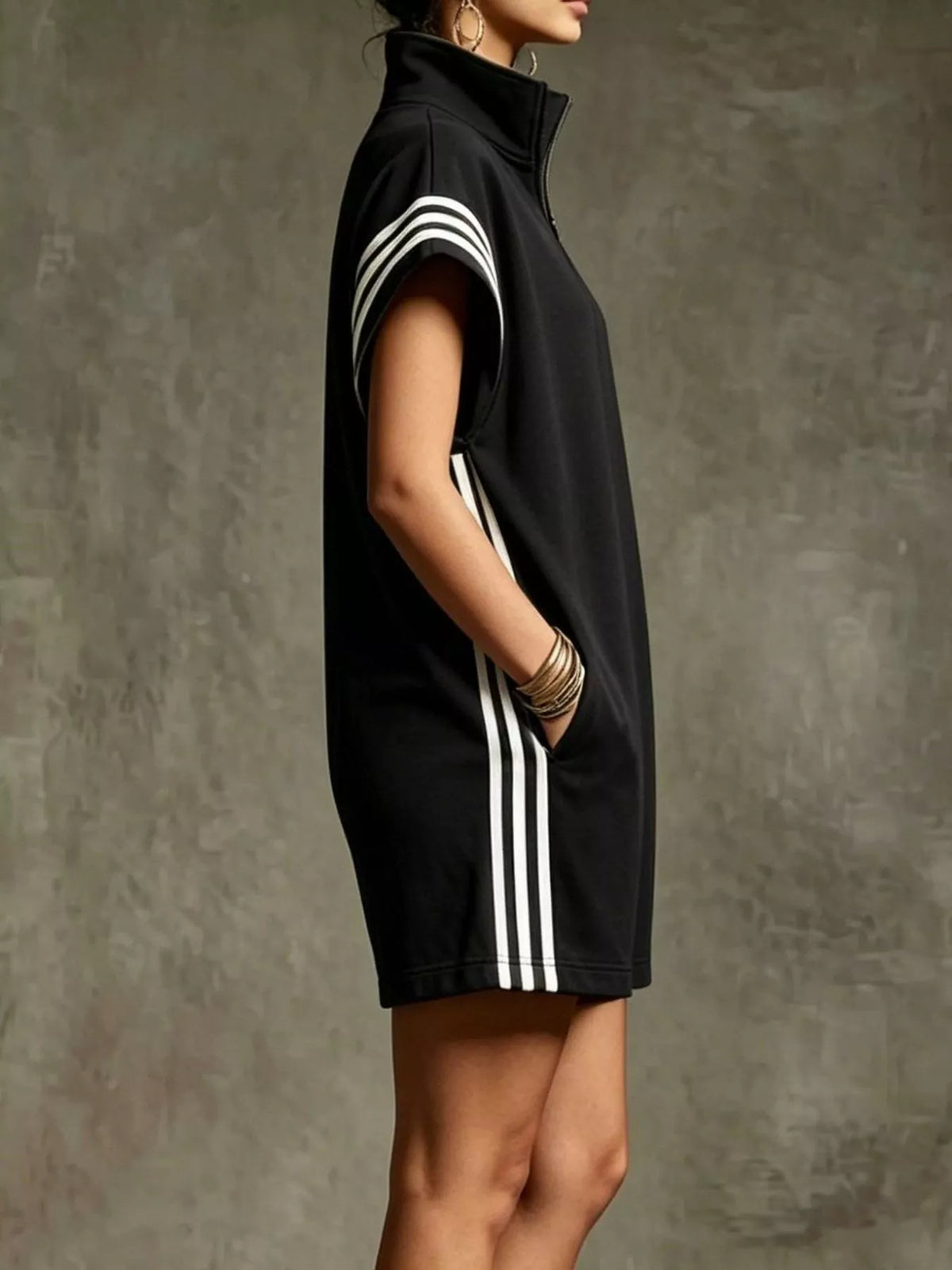Black dress with white stripes on a textured gray background