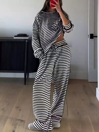 Person wearing a black and white striped outfit in a room.