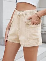 Beige shorts worn by a person with a blurred background