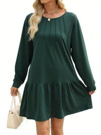 Green dress with long sleeves on a white background
