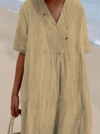 Person wearing a beige dress with a blurred background