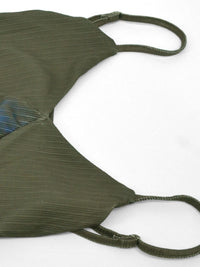 Green bikini top on a white background