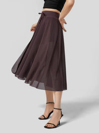 Brown skirt worn by a person on a light gray background