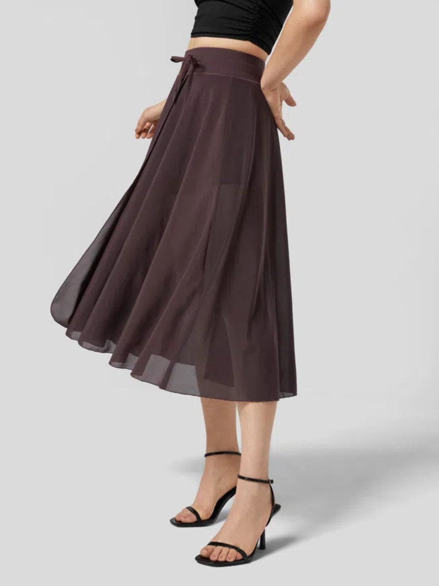 Brown skirt worn by a person on a light gray background
