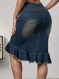 Denim skirt with ruffled hem on a plain background