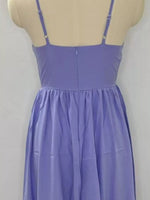 Purple dress on a mannequin against a plain background