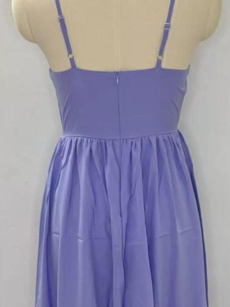 Purple dress on a mannequin against a plain background