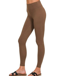 Brown leggings worn by a person on a white background