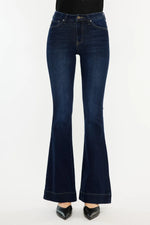 Dark blue flared jeans on a white background