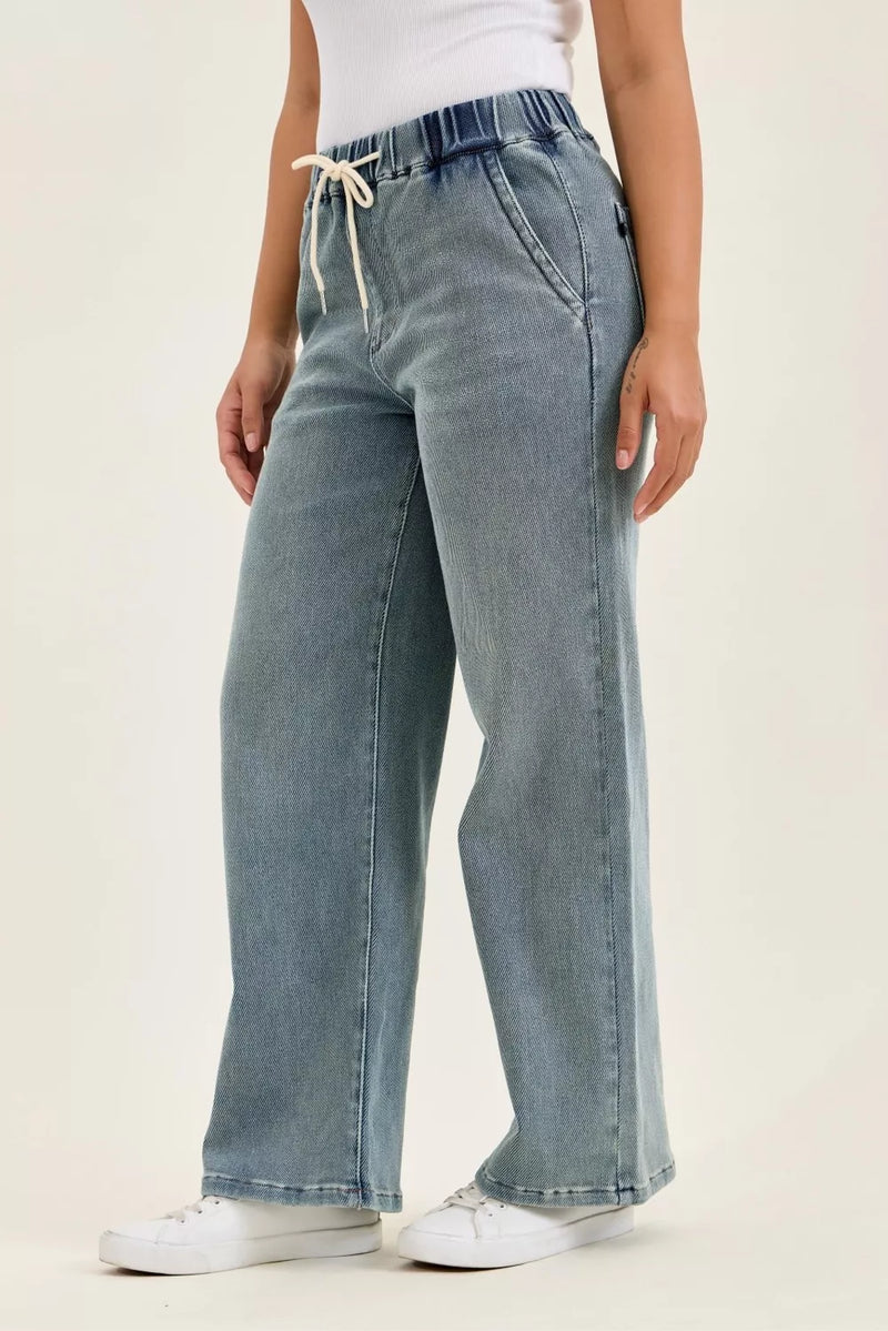 Light blue jeans worn by a person on a white background