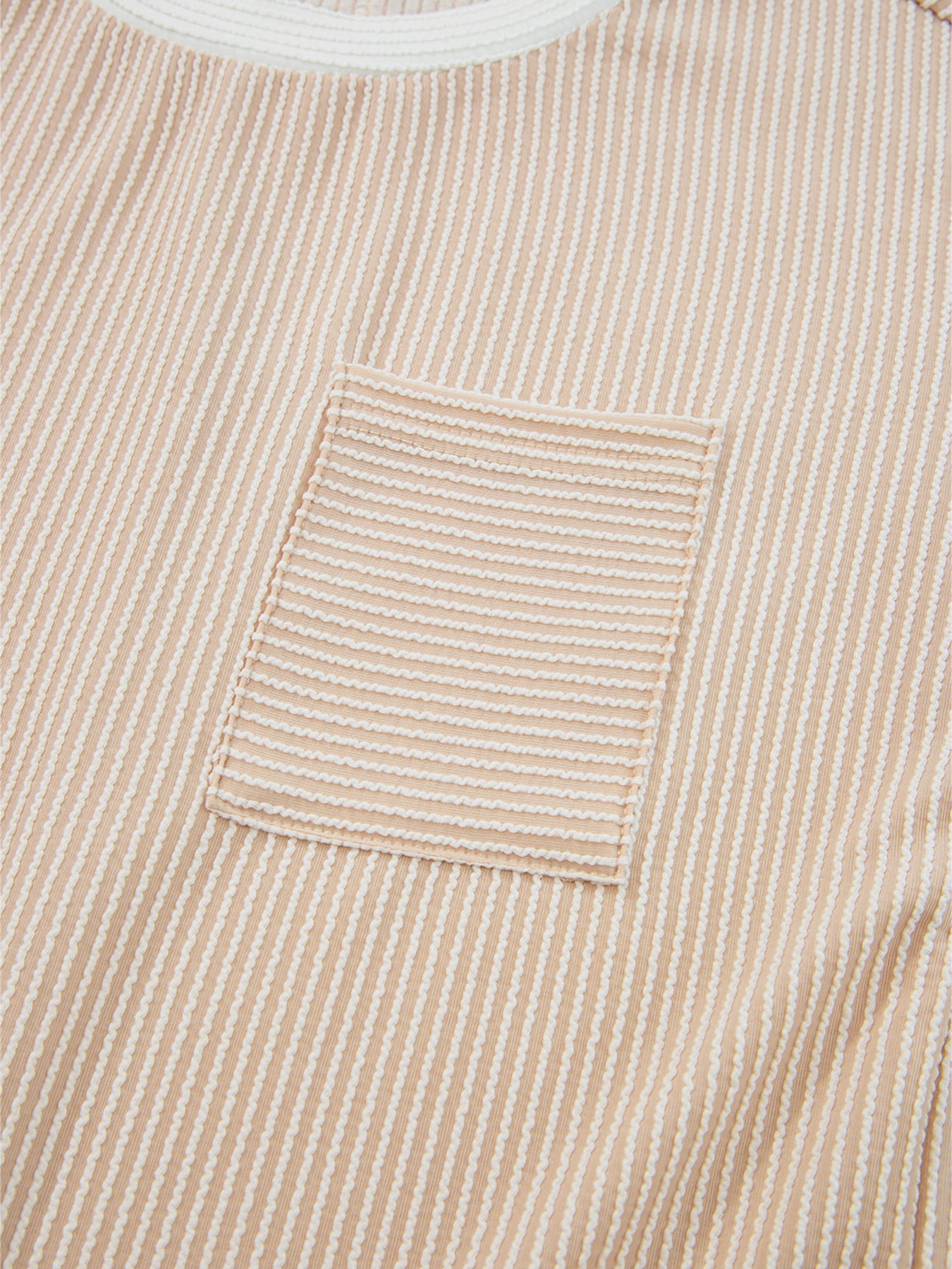 Close-up of a beige corduroy shirt with a pocket