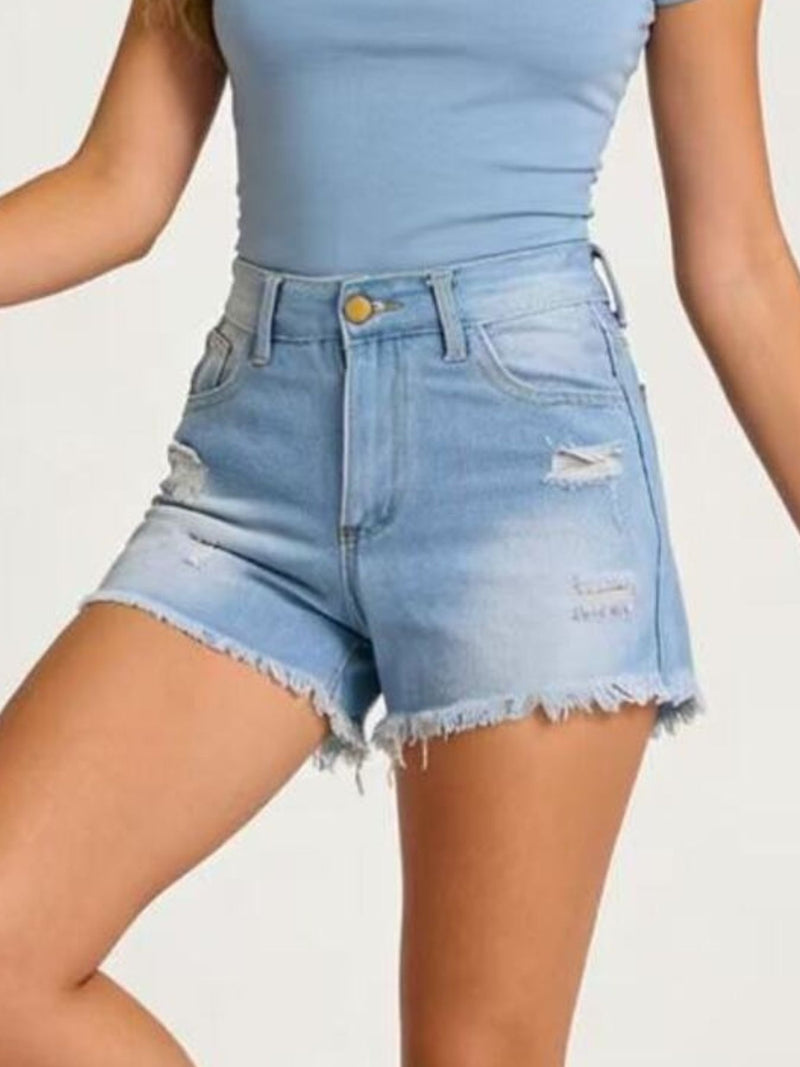 Light blue denim shorts worn by a person on a plain background