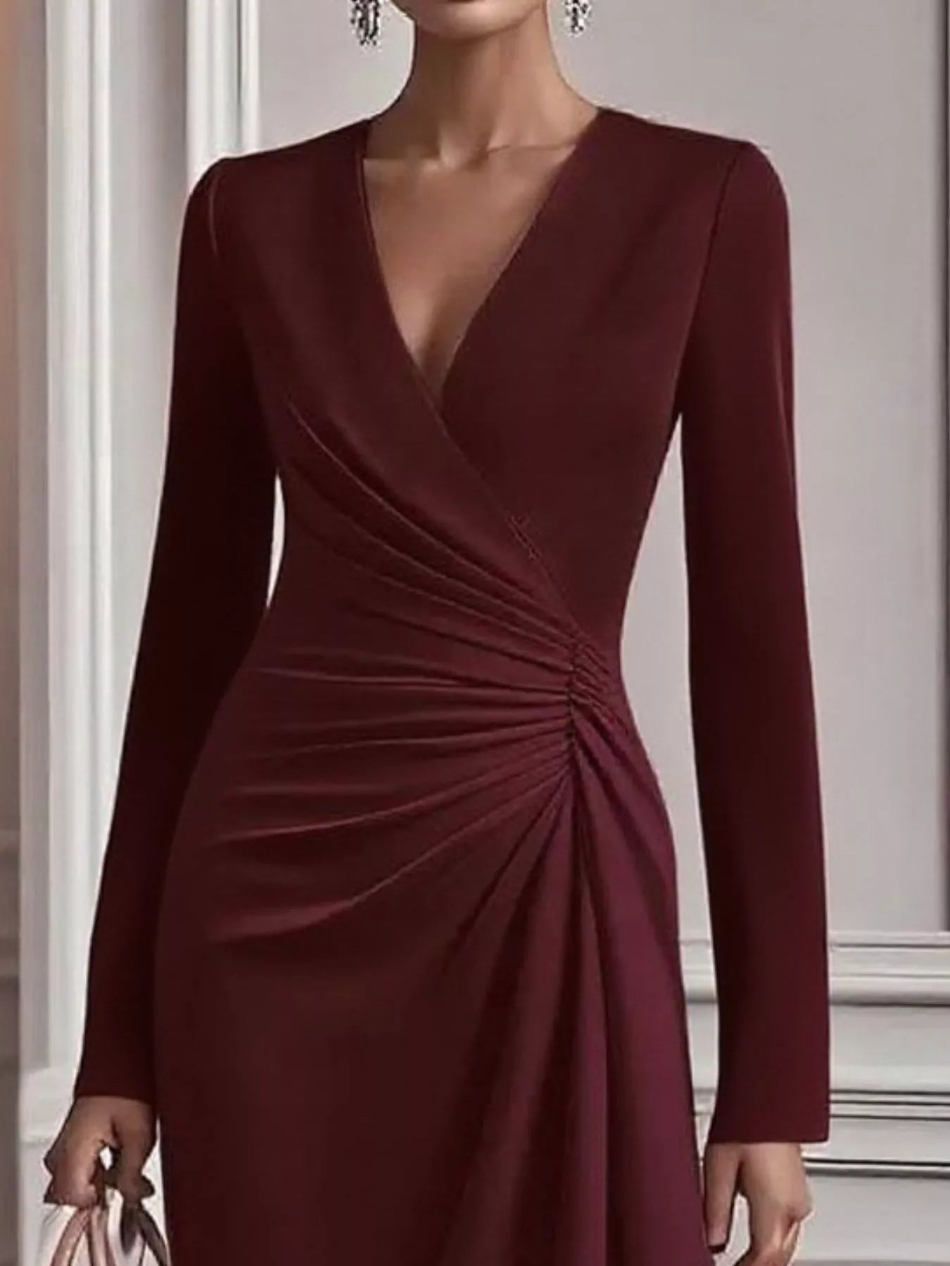Burgundy dress with long sleeves on a neutral background