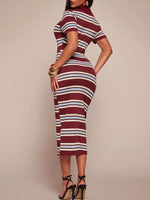Woman wearing a striped dress with a plain background