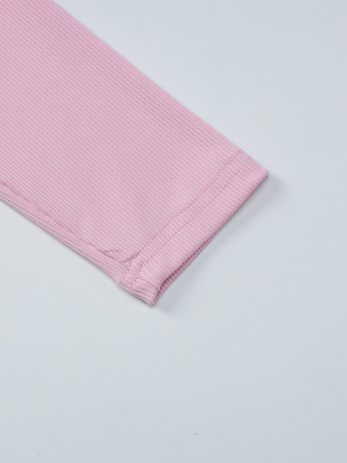 Pink textured fabric on a light gray background