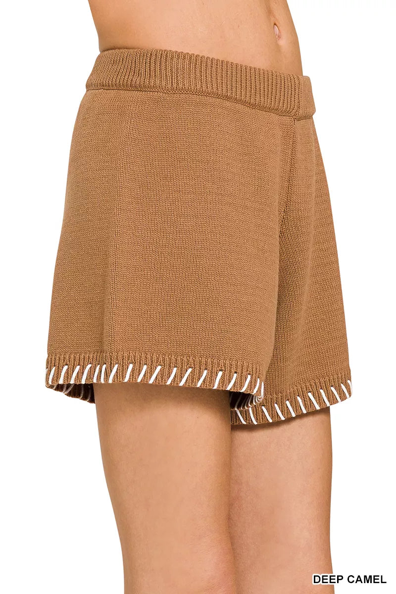 Brown knit skirt with white trim on a white background