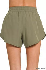 Olive green shorts on a white background