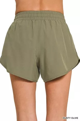 Olive green shorts on a white background