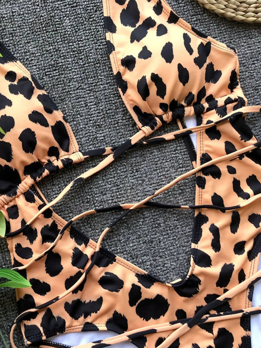 Leopard print bikini top on a textured surface