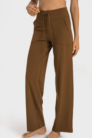 Brown wide-leg pants worn by a person on a white background
