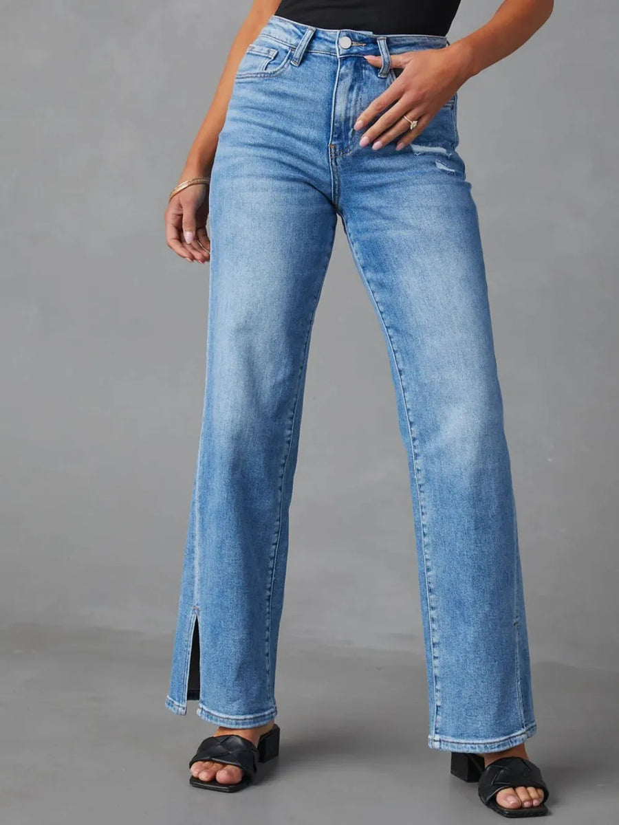 Person wearing blue jeans on a gray background